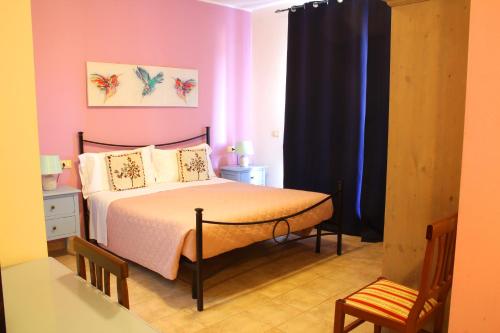 a bedroom with a bed and a black curtain at Country House La Foggetta in Pineto