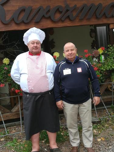 two men standing next to each other in front of a building at Dwa Dęby in Lubawka