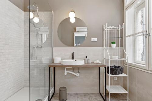 a bathroom with a sink and a shower at Apartments Carpathia in Rijeka