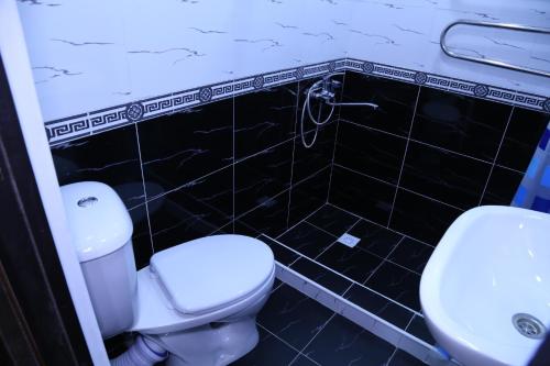 a bathroom with a toilet and a sink at Khiva Ibrohim Guest House in Khiva