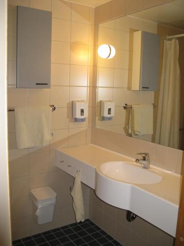 a bathroom with a sink and a toilet at Unicare Røros in Røros
