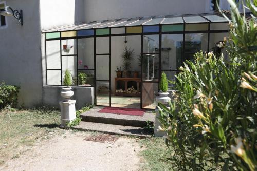 a glass greenhouse with a potted plant in it at Justin de Provence in Orange