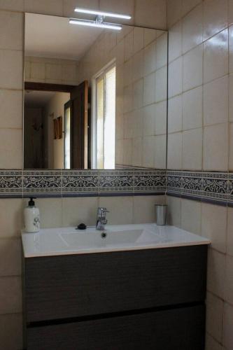 a bathroom with a sink and a mirror at Casa Rural Los Membrillos in Teba