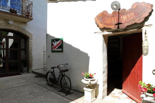 a bike parked outside of a building with a sign at Justin de Provence in Orange