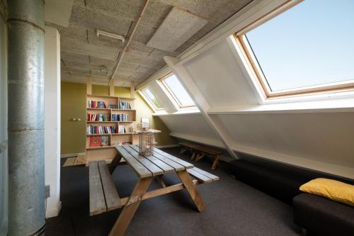 a room with a table and a book shelf at Rufus aan het water in Broek