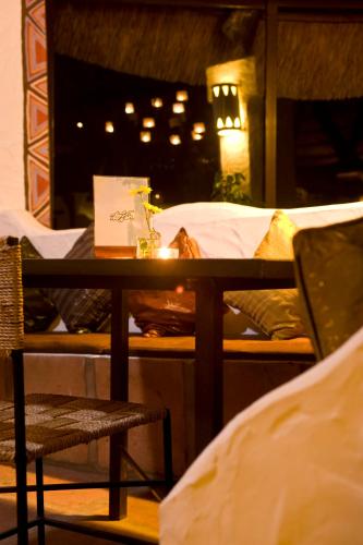 a table and chairs in a room with beds at 100% Fun in Tarifa