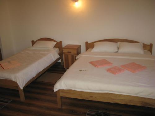 two beds sitting next to each other in a room at Vodenica Lug in Strmosten