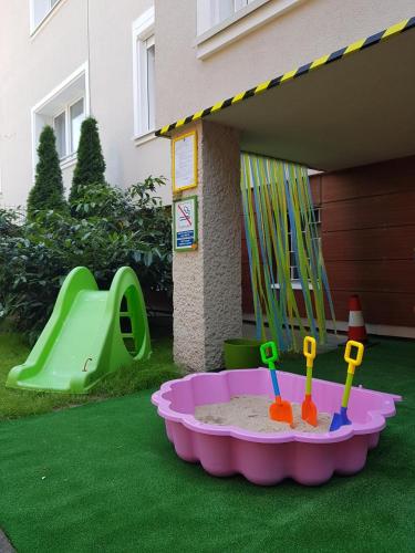 a toy sandbox in a yard with a playground at Hotel Gold in Poznań