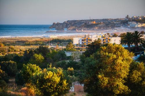 a view of a beach with buildings and the ocean at Moonshine Guest House with private studios and private cottage in Lagos