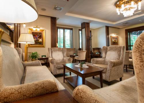 a living room with couches and chairs and a table at Hotel & Spa PALIĆ RESORT in Palić