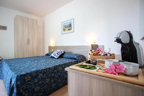 a hotel room with a bed and a table with food at Colibrì in Maierà