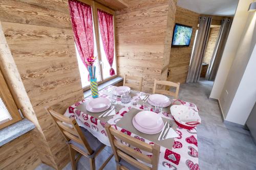 a dining room with a table in a log cabin at Fenat in Introd
