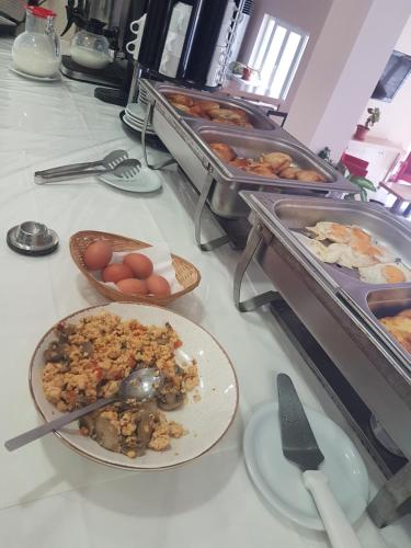 a buffet with plates of food on a table at Glyfada Beach Hotel in Glyfada