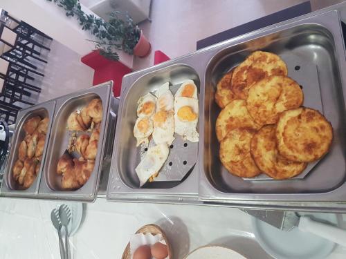three trays of food sitting on a table at Glyfada Beach Hotel in Glyfada