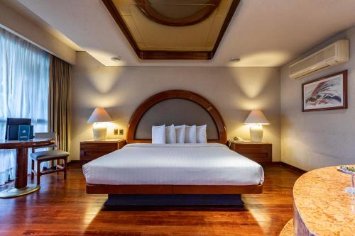 Säng eller sängar i ett rum på Hotel Beverly