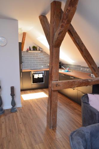 a kitchen and living room with wooden beams in a room at Hygge in Clenze