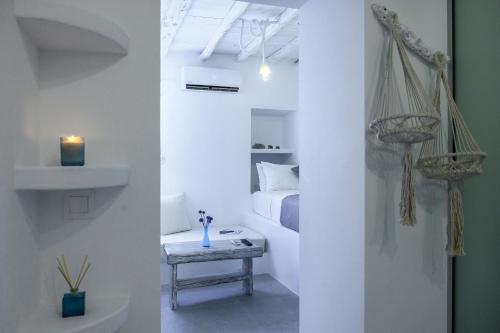 a room with a bed and a table with a candle at Milinon Suites in Firopótamos