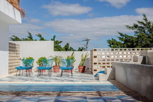 a group of blue chairs on a patio at Studios Downtown Cancun in Cancún