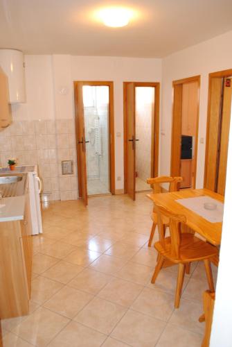 a kitchen and dining room with a table and chairs at Vila DeLux in Negotin