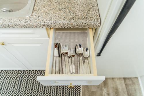 a drawer filled with silver utensils under a counter at 1BR Modern Apt in the Heart of the City - Marshfield G in Chicago