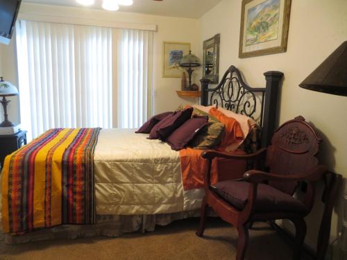 a bedroom with a bed and a chair and a window at Always Inn San Clemente Bed & Breakfast by Elevate Rooms in San Clemente