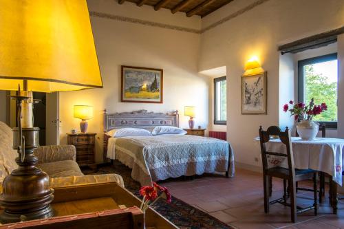 a bedroom with a bed and a couch and a table at Casa Torrini in Fiesole