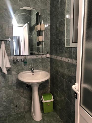 a bathroom with a sink and a mirror at Apartmani Dini in Ulcinj