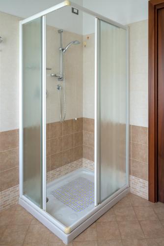 a shower with a glass enclosure in a bathroom at CASA LAINI in Pisogne