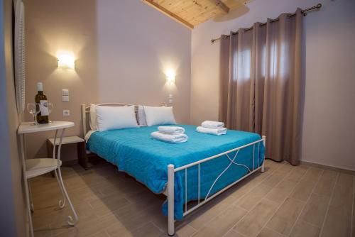 a bedroom with a bed with towels on it at Camping & Rooms Kariotes in Lygia