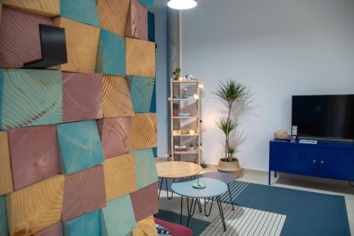 a room with a wall with a table and chairs at Apartments Steel Residence -Tesla Test Drive and 120 kW Supercharger in Timişoara