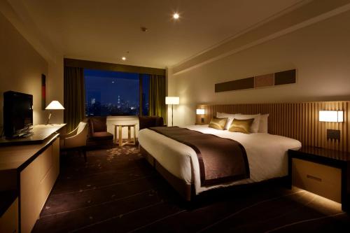 a hotel room with a large bed and a window at The Prince Sakura Tower Tokyo, Autograph Collection in Tokyo