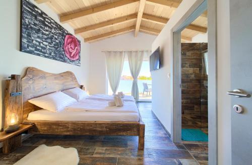 a bedroom with a bed and a window at Pax Houses in Krk