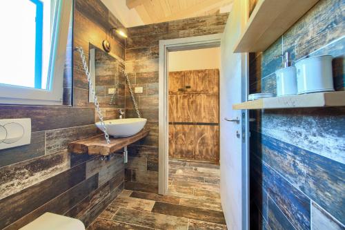 a bathroom with a toilet and a sink at Pax Houses in Krk