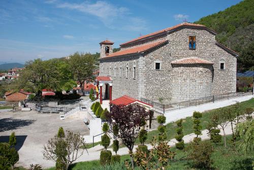 a large stone building with a clock tower on it at Agrelia in Agreliá