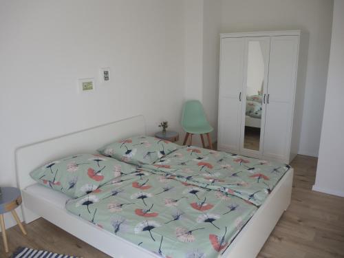 a bedroom with a bed with a colorful comforter at Ferienwohnung Saig in Lenzkirch