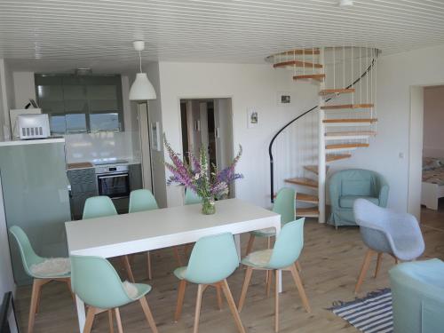 a kitchen and dining room with a white table and chairs at Ferienwohnung Saig in Lenzkirch