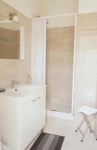 a white bathroom with a sink and a shower at B&B San Francesco in Nicosia