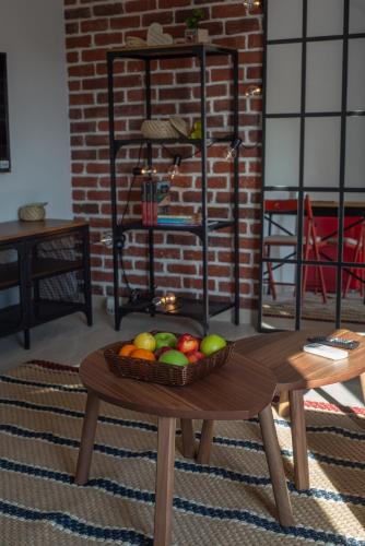 a bowl of fruit on a table in a room at Apartments Steel Residence -Tesla Test Drive and 120 kW Supercharger in Timişoara