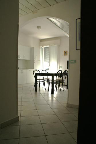 a dining room with a table and chairs in a room at Residence Le Vele in Cattolica