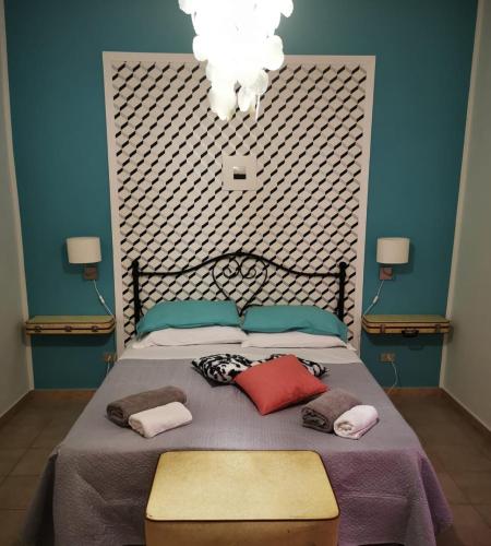 a bedroom with a large bed with pillows on it at Alter Ego in Lascari