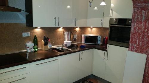 Kuchyň nebo kuchyňský kout v ubytování Sana apartment