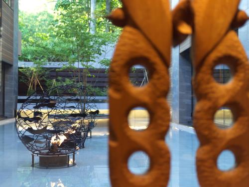 a view of a table and chairs through a window at Lake Shikotsu Tsuruga Bessou AO no ZA in Chitose