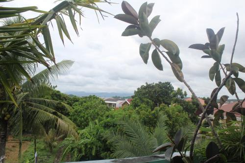 a view of a jungle with trees and houses at Maraño's Home in Legazpi