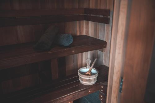 a shelf in a room with a bucket and a mortar and pestle at The Louise in Marananga