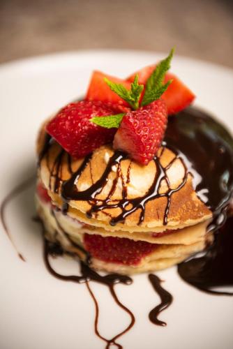 a dessert with strawberries and chocolate on a plate at Apollon Windmill Boutique Hotel - Adults Only in Kos Town