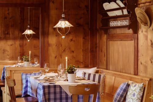 a dining room with a table with chairs and candles at Berghotel Ladinia in Corvara in Badia