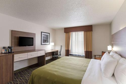 a hotel room with a bed and a flat screen tv at Quality Inn Williams Near Grand Canyon in Williams
