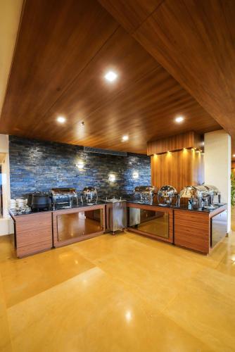a large kitchen with many pots and pans at KPM TRIPENTA HOTEL in Kozhikode