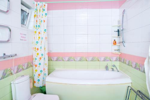 a bathroom with a toilet and a shower curtain at Дом вблизи моря in Odesa