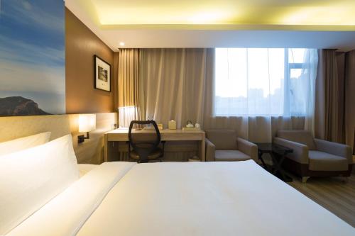 a hotel room with a bed and a desk at Atour Hotel (Taiyuan Zonggai Shifanqu) in Taiyuan